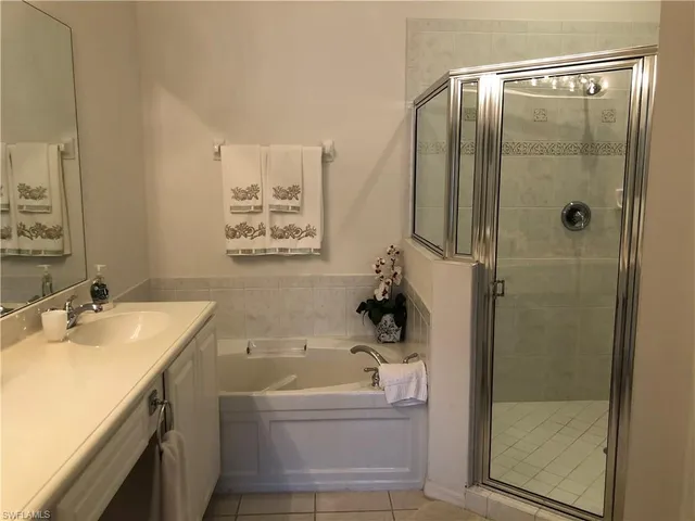a bathroom with a tub sink and mirror