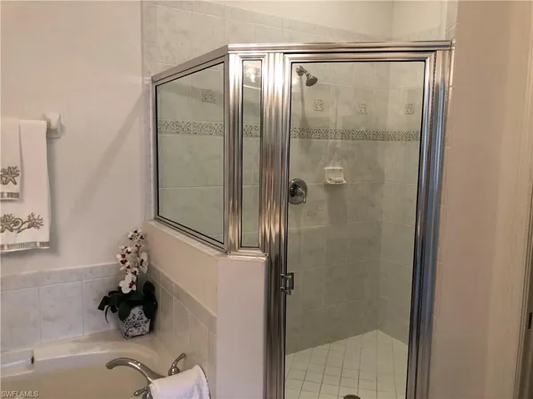 a bathroom with a glass shower door