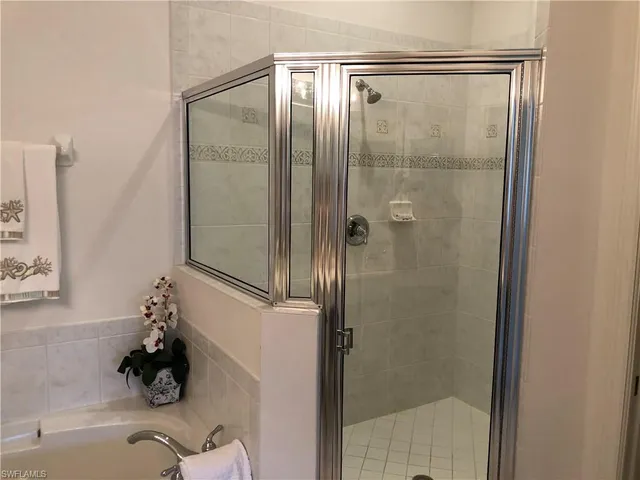 a bathroom with a glass shower door