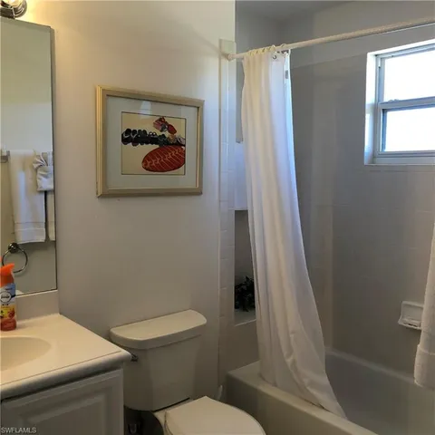 a white toilet sitting next to a bathroom sink