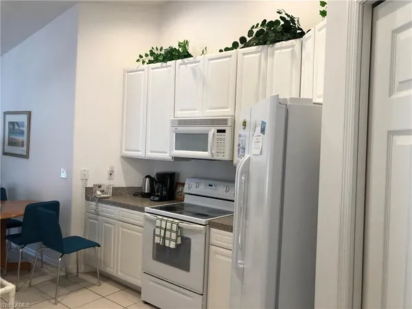 a kitchen with stainless steel appliances a refrigerator a sink and cabinets