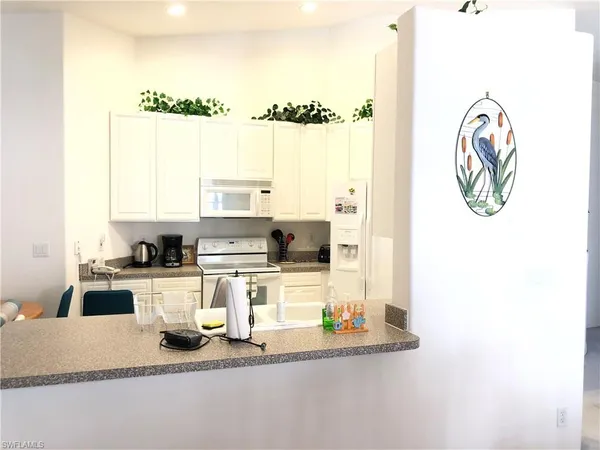 a kitchen with a refrigerator and a stove top oven
