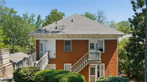 a aerial view of a house with a yard and potted plants