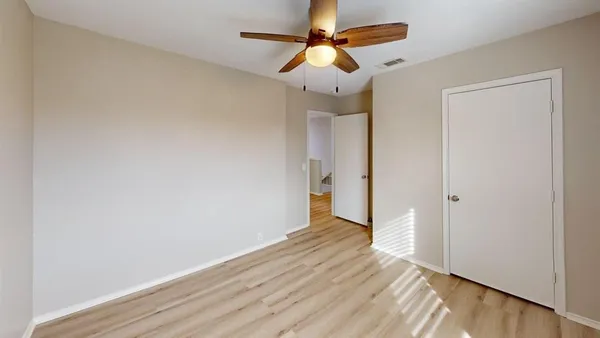 a view of a room with wooden floor