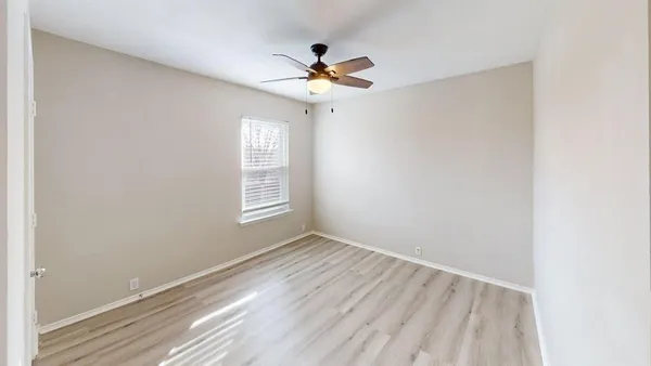 a view of a livingroom with a ceiling fan and window