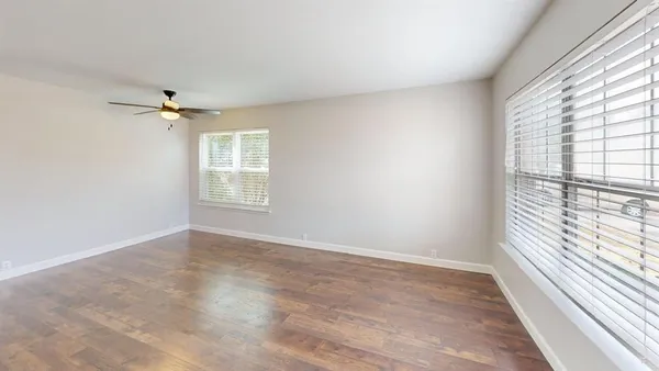 wooden floor in an empty room with a window