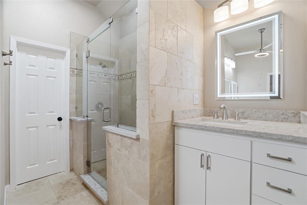 2133 Rustic Ridge Drive Keller, TX 76248 - Photo 30 of 40 Primary bathroom featuring vanity, a stall shower, a ceiling fan, and light tile patterned floors
