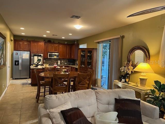 10025 Winding River Road Punta Gorda, FL 33950 - Photo 11 of 30 a kitchen with a refrigerator and a dining table