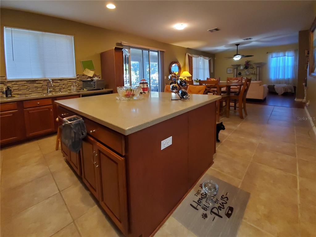10025 Winding River Road Punta Gorda, FL 33950 - Photo 15 of 30 a kitchen with stainless steel appliances granite countertop a sink counter space and a stove top oven