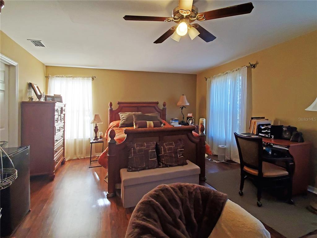10025 Winding River Road Punta Gorda, FL 33950 - Photo 17 of 30 a bedroom with furniture and a window