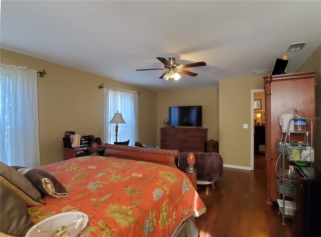 10025 Winding River Road Punta Gorda, FL 33950 - Photo 18 of 30 a bed room with a bed and a chandelier