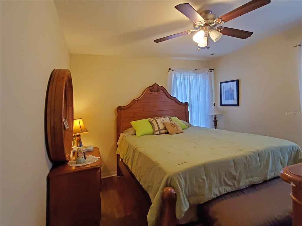 10025 Winding River Road Punta Gorda, FL 33950 - Photo 22 of 30 a bedroom with a bed and a chandelier