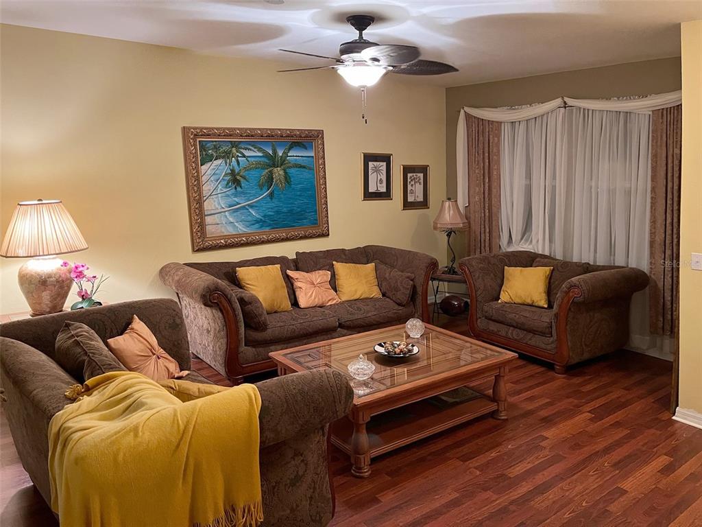 10025 Winding River Road Punta Gorda, FL 33950 - Photo 6 of 30 a living room with furniture a couch and a chandelier