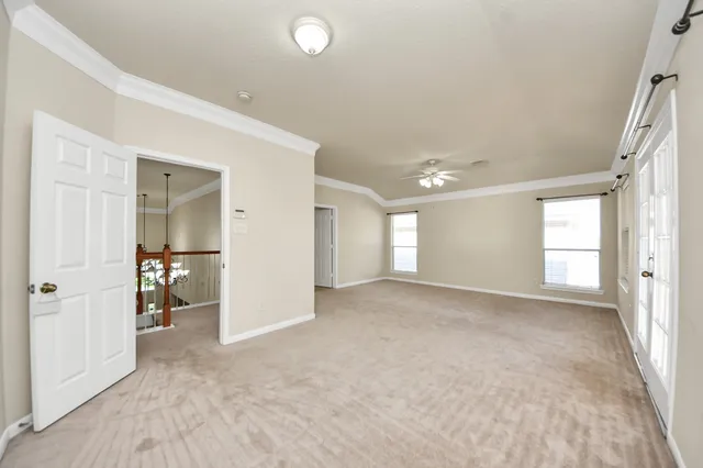 an empty room with windows and closet