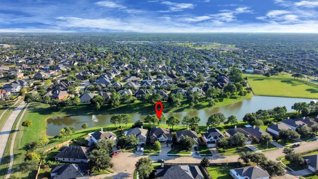 an aerial view of residential house with outdoor space and lake view