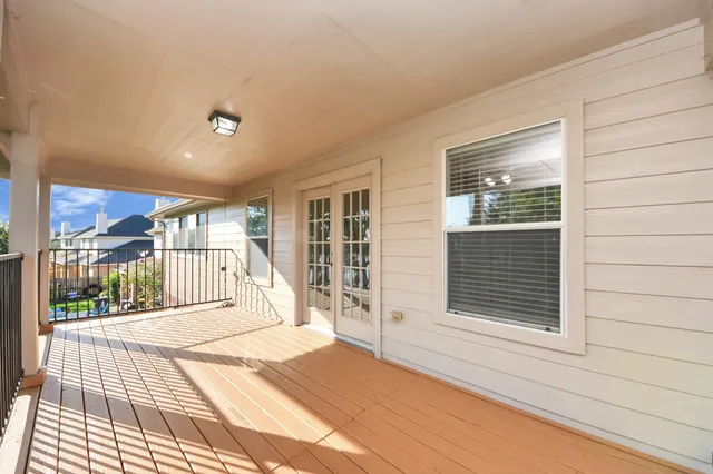 a view of a balcony with wooden floor