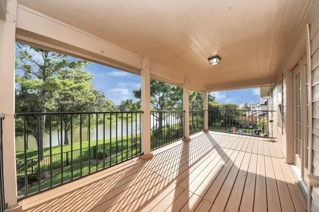 a view of a balcony with wooden floor