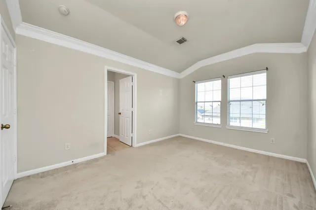 an empty room with a empty space and windows