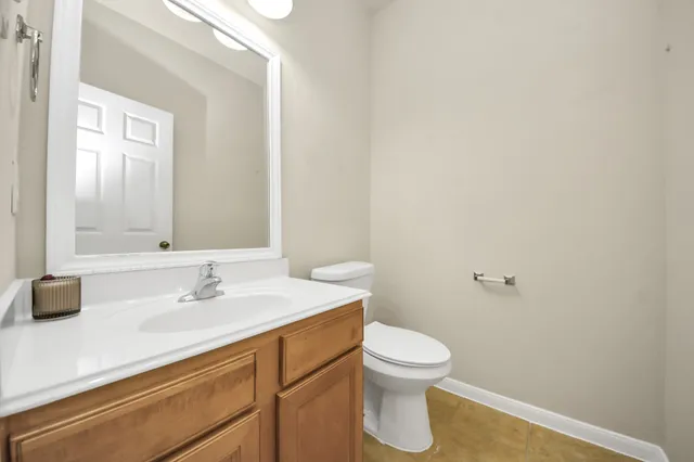 a bathroom with a sink a toilet and mirror