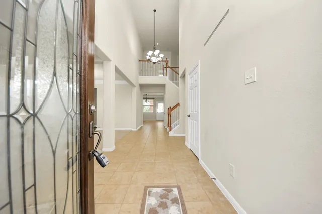 a view of a hallway with a chandelier