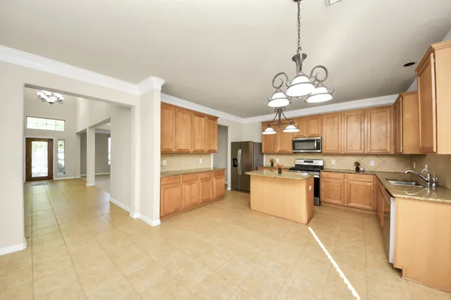 a view of a kitchen with a sink and chandelier