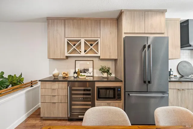 a kitchen with stainless steel appliances granite countertop a refrigerator sink and cabinets