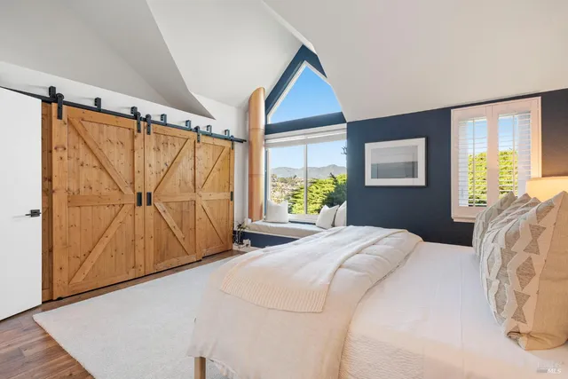 a bedroom with a bed and a window with the outer view