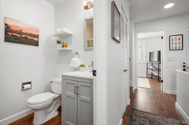 a white toilet sitting next to a bathroom sink