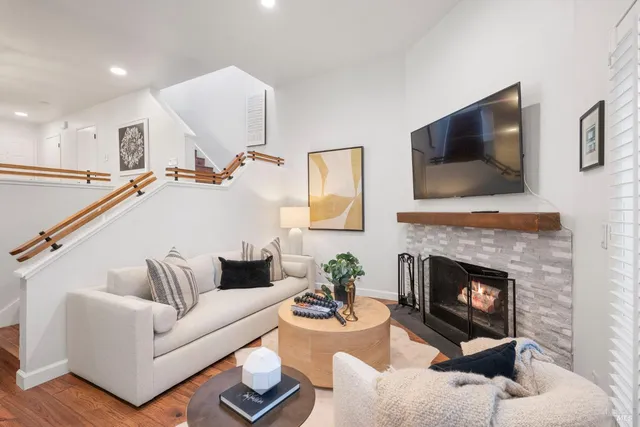 a living room with furniture and a fireplace
