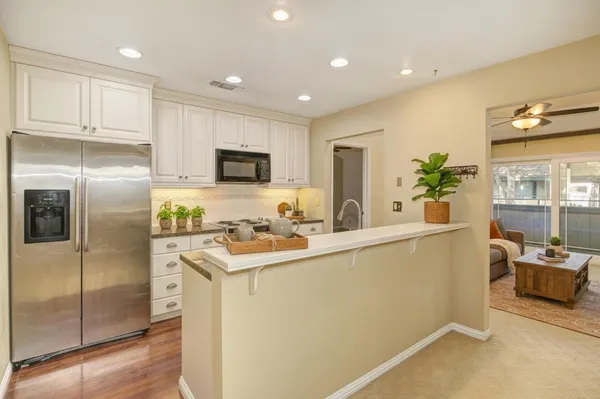 a kitchen with a refrigerator and a sink