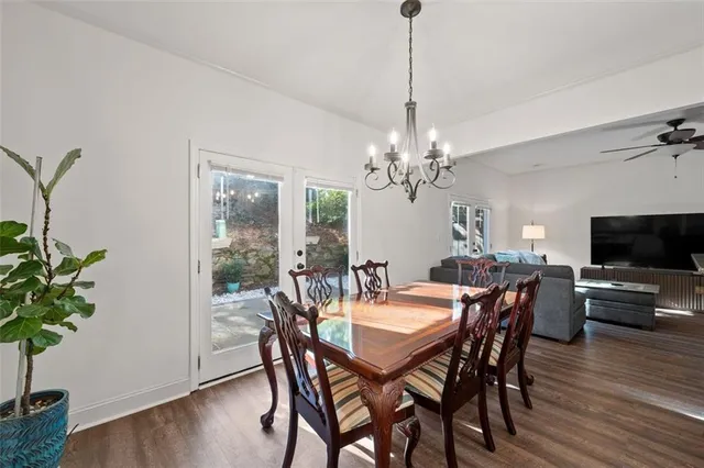 a view of a dining room with furniture wooden floor and chandelier