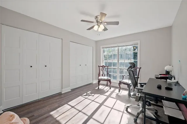 a workspace with wooden floor and a chandelier fan