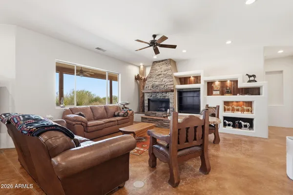 a kitchen with stainless steel appliances granite countertop a stove top oven a sink dishwasher a dining table and chairs with wooden floor