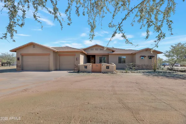 a kitchen with stainless steel appliances granite countertop a stove top oven a sink a dining table and chairs with wooden floor