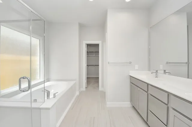 a bathroom with a bathtub and a sink