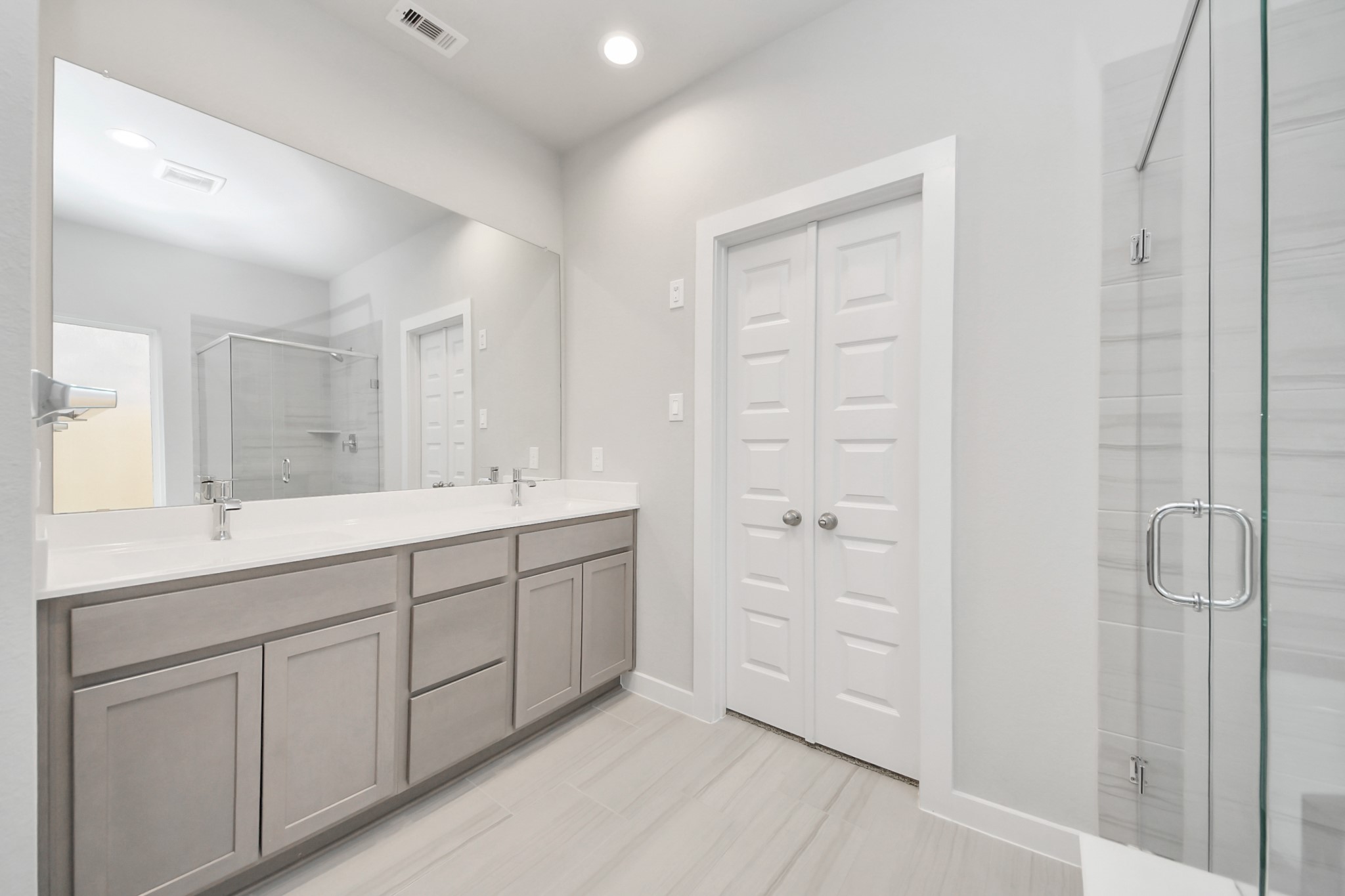 14906 Rural Rdg Road Cypress, TX 77429 - Photo 24 of 46 a spacious bathroom with a double vanity sink a mirror and shower