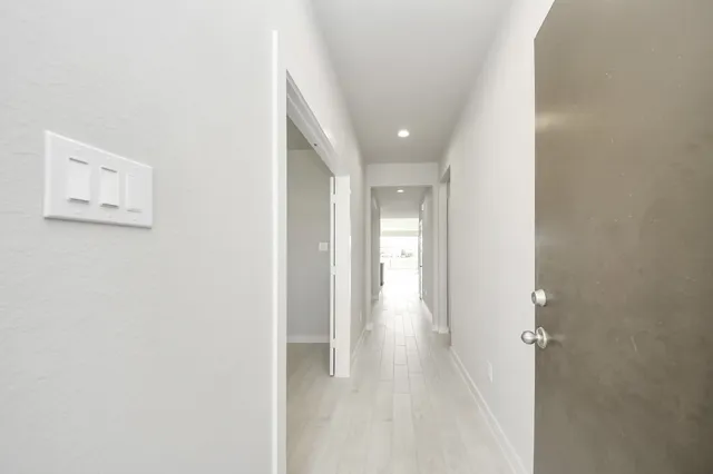 a view of a hallway with wooden floor