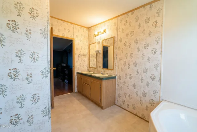 a bathroom with a granite countertop sink a toilet and shower