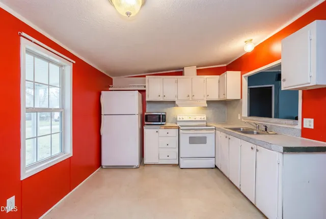 a kitchen with stainless steel appliances granite countertop a refrigerator a stove top oven a sink and dishwasher