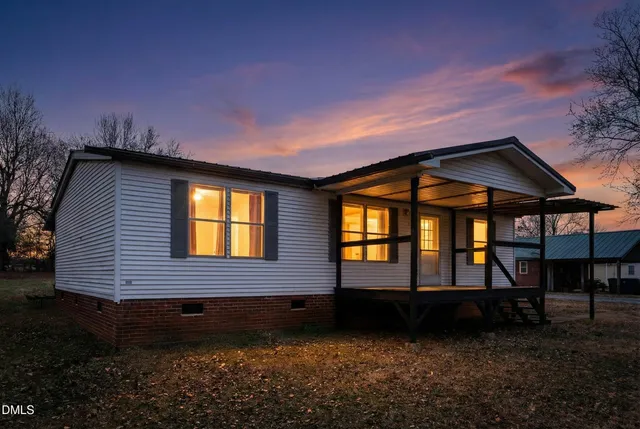 a view of house with backyard and garden