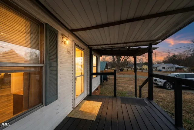 a view of a balcony with furniture and wooden floor