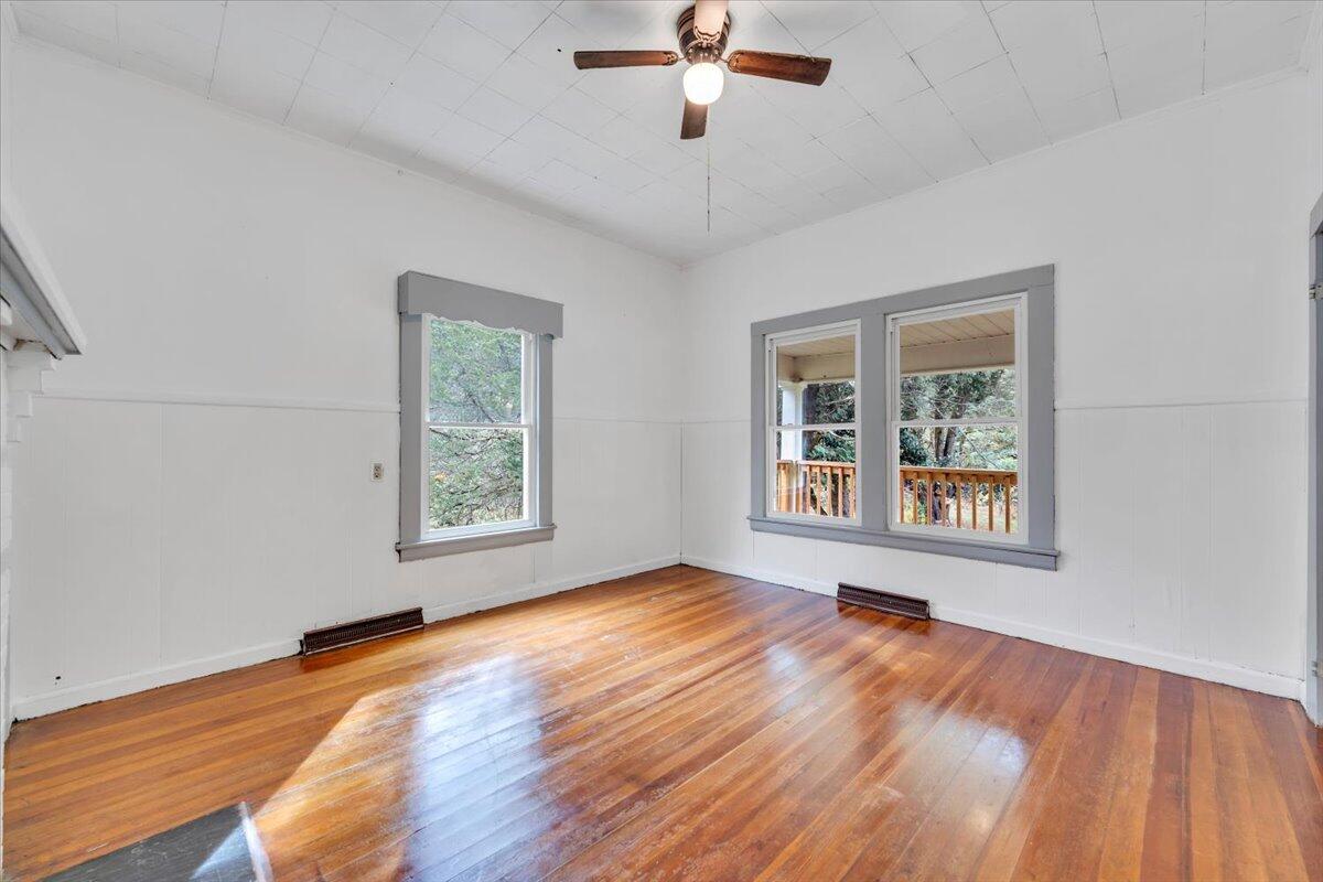 6973 Henry Road Henry, VA 24102 - Photo 12 of 110 a view of an empty room with wooden floor and a window