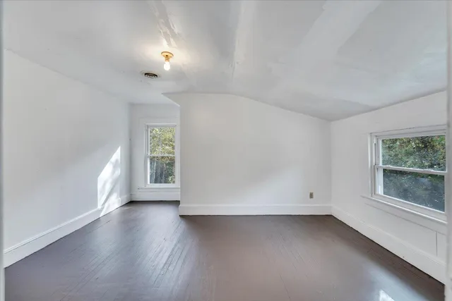 an empty room with closet and a chandelier fan