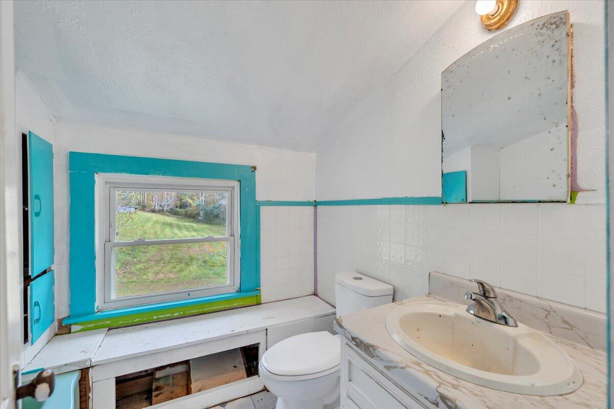 6973 Henry Road Henry, VA 24102 - Photo 34 of 110 a bathroom with a sink and a toilet