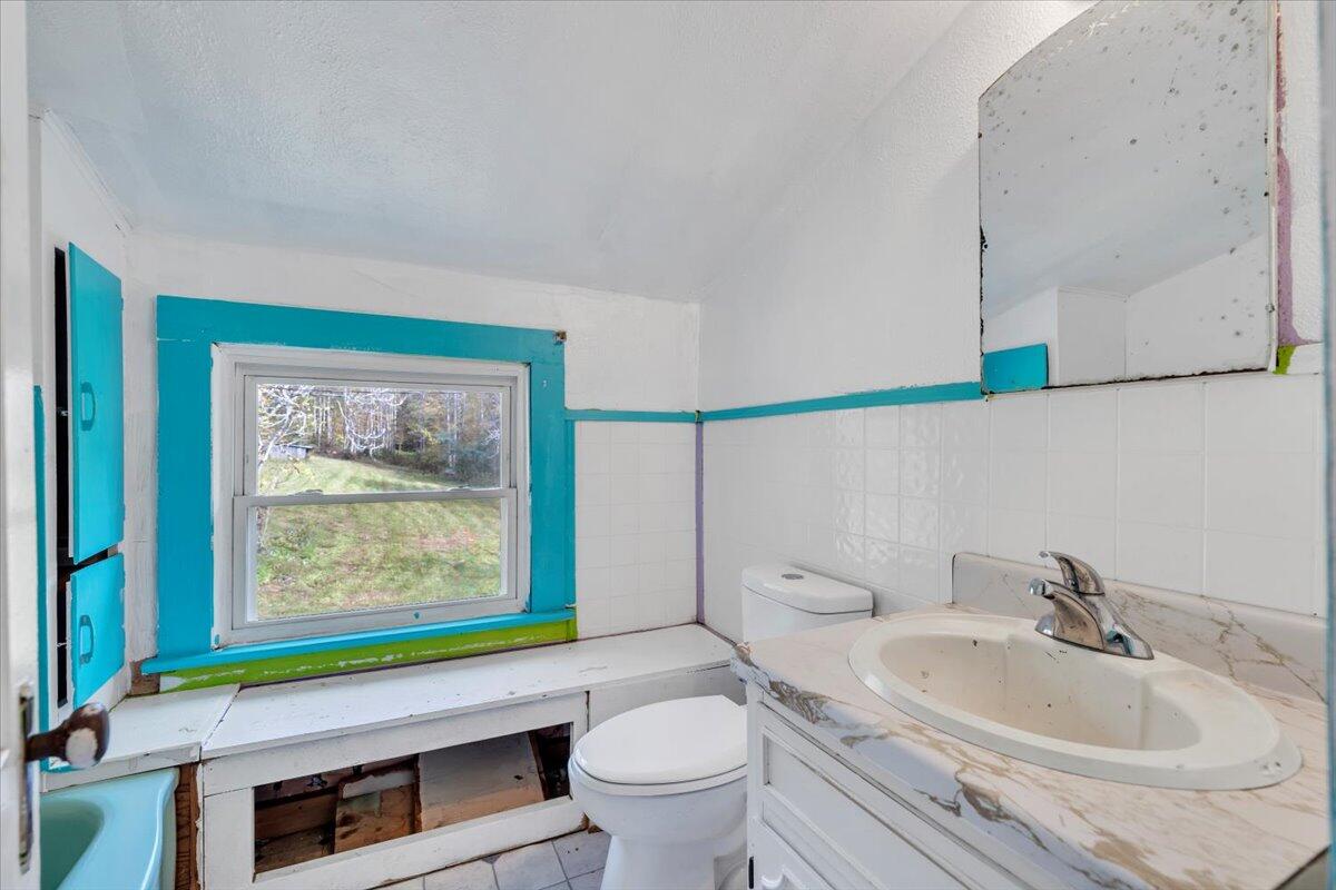 6973 Henry Road Henry, VA 24102 - Photo 35 of 110 a bathroom with a sink a toilet and a window