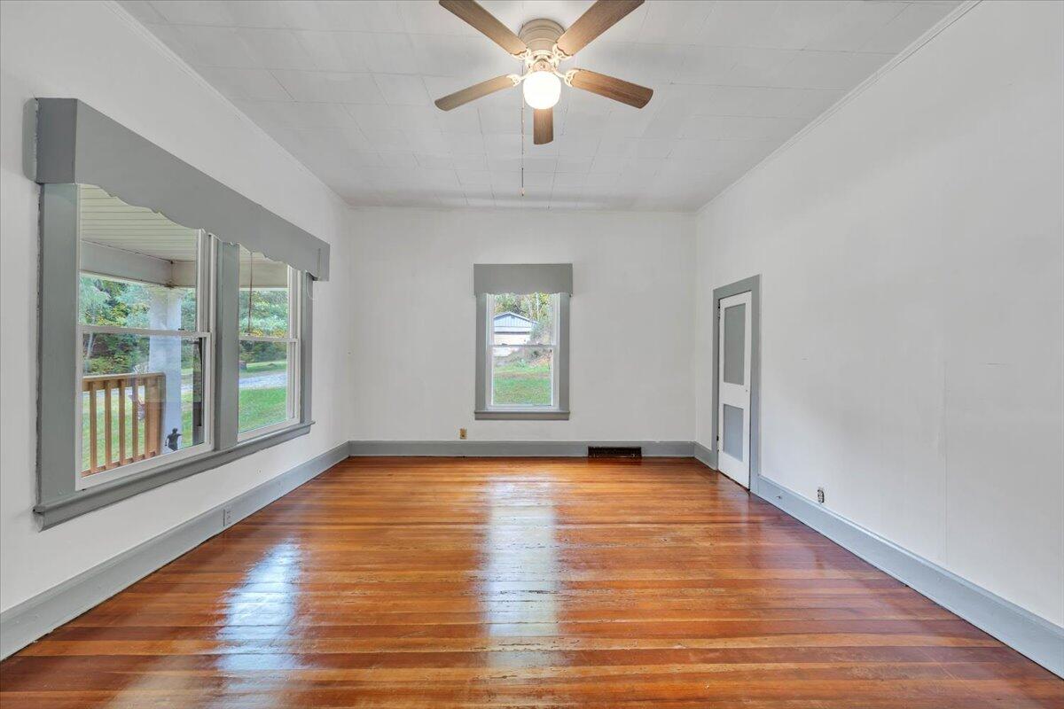 6973 Henry Road Henry, VA 24102 - Photo 4 of 110 a view of an empty room with window and wooden floor