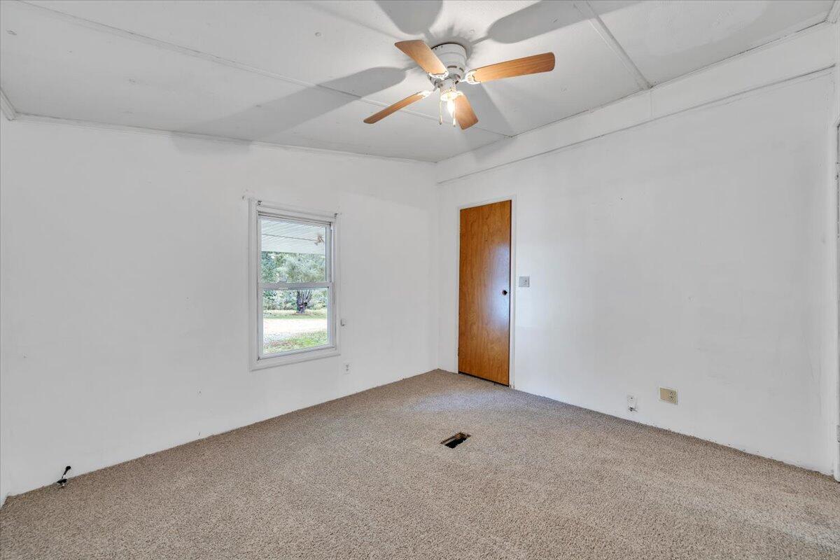 6973 Henry Road Henry, VA 24102 - Photo 55 of 110 an empty room with windows and fan chandelier fan