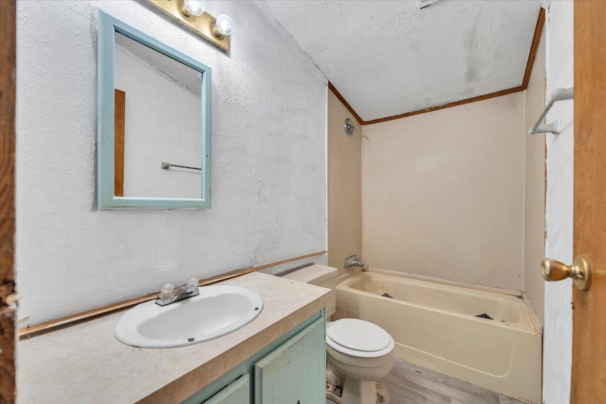 6973 Henry Road Henry, VA 24102 - Photo 56 of 110 a bathroom with a granite countertop sink toilet and shower