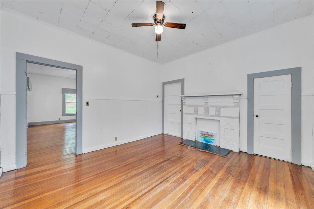 6973 Henry Road Henry, VA 24102 - Photo 10 of 110 a view of empty room with wooden floor and ceiling fan