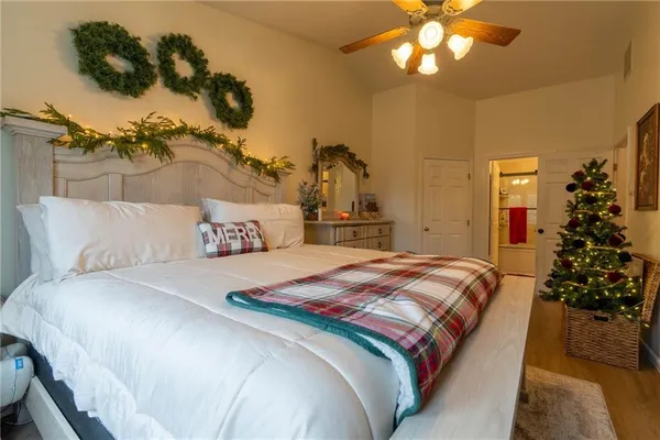 a bedroom with a bed and a chandelier